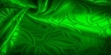 Yapraksı çiçek desenli yeşil kumaş yakın plan, yumuşak, pürüzsüz dokusu ve hassas ışık ve gölge oyunu sergileniyor..