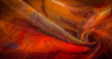 Canlı turuncu, kırmızı ve mor renkli yumuşak, akışkan bir kumaşın yakın çekimi soyut ve dinamik bir deseni ve karmaşık kıvrımları gösteriyor..