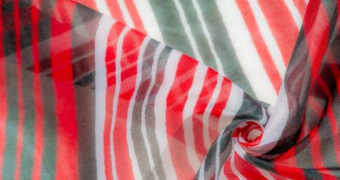 Kırmızı, siyah ve beyaz tonlarında, karmaşık dalga desenli canlı çizgili bir kumaş. Katlar hareket ve derinlik yaratır. Moda için ideal materyalin dinamik görünümüne eklenir.