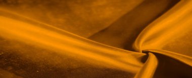 Yumuşak kıvrımlı pürüzsüz bir altın kumaş parçası. Derin gölgelerle soyut bir şekil oluşturuyor. Aydınlık ve karanlık arasındaki etkileşim zengin ve zarif bir görsel cazibe yaratır..