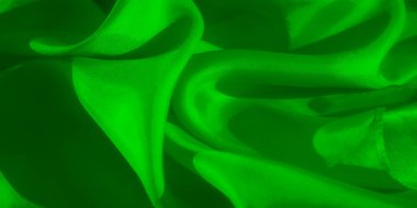 Pürüzsüz kıvrımları ve yumuşak dokuları olan parlak yeşil bir kumaş. Işık ve gölgeyle işaretlenmiş. Resmin soyut doğası onun estetik çekiciliğini arttırır..