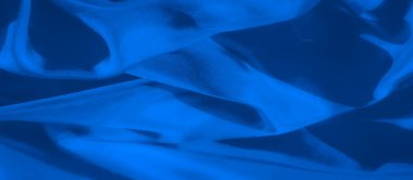 Yumuşak dalgalar ve karmaşık kıvrımları olan pürüzsüz, akışkan mavi bir kumaş. Işıklandırma dokuyu geliştirir, resmi soyut, modern tasarım ve sanatsal ifade için mükemmel kılar..