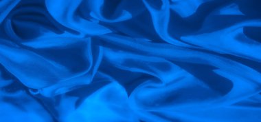 Yumuşak ve nazik kıvrımlarda akan canlı, soyut mavi kumaş. Bu yüksek çözünürlüklü resim düz dokuyu ve ince desenleri vurgular, arka plan veya tekstil uygulamaları için mükemmeldir.