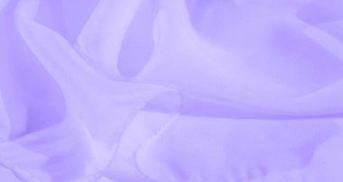 Yumuşak lavanta renklerinde bulanık kumaş kıvrımları soyut bir doku yaratır. Işığın ve gölgenin etkileşimi rahatlatıcı bir estetik sunuyor. Huzurlu ve rahatlatıcı arka planlar için mükemmel..