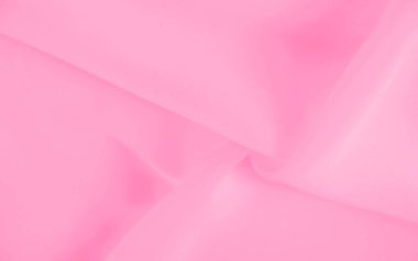 Yumuşak kıvrımlı, bulanık pembe kumaş zengin bir doku ve derinlik yaratıyor. Açık pembe ton, maddenin narin, havadar ve akışkan görünümünü arttırır..