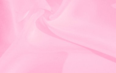 Yumuşak kıvrımları ve pürüzsüz dokusu olan bulanık pembe kumaş. Malzemenin hassas dalgaları havadar, kadınsı bir görünüm yaratıyor, tekstil ve moda arka planlarında kullanmak için mükemmel..