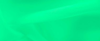 Yumuşak, akışkan kıvrımlı ve pürüzsüz yüzeyi olan bulanık yeşil kumaş. Işık ve gölge oyunu, tekstil ve tasarım için ideal, dinamik ama sakin bir kompozisyon yaratır..