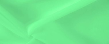 Yumuşak, dalgalı bulanık yeşil kumaş sakinleştirici bir etki yaratıyor. Bükümlerdeki ışık dokusu ve gradyanı kumaşın doğal hareketini vurgular ve mükemmel bir arkaplan sunar.