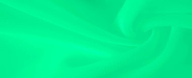 Yumuşak, dalgalı bulanık yeşil kumaş sakinleştirici bir etki yaratıyor. Bükümlerdeki ışık dokusu ve gradyanı kumaşın doğal hareketini vurgular ve mükemmel bir arkaplan sunar.