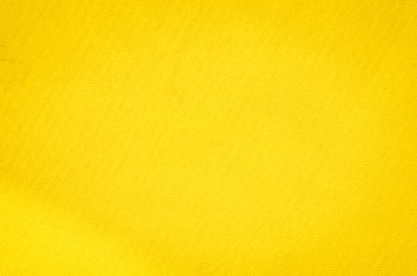Blurred yellow fabric with intricate draping, forming soft, overlapping folds. The vibrant yellow creates a glowing, textured surface, perfect for abstract and minimalist design.