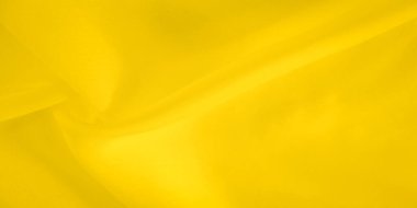 Bulanık açık sarı kumaş, yumuşak ve akışkan bir yüzey oluşturur ve ince kıvrımlar doku ekler. Yumuşak kumaş nazikçe eğilir, dinamik ama rahatlatıcı bir görsel sunar..