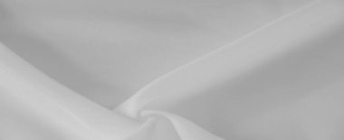 Bulanık beyaz kumaş yumuşak, akışkan kıvrımlı ve pürüzsüz bir dokuya sahiptir. Minimalist estetik ve ince ışık oyunu zarafet ve saflığı çağrıştırıyor, sakinleştirici ve huzurlu bir tasarım yaratıyor..