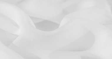 Akan kıvrımları ve pürüzsüz, pürüzsüz dokusu olan bulanık beyaz kumaş. Yumuşak tasarım minimalizm ve zarafet yayar, ince ışık onun temiz ve saf estetiğini güçlendirir..