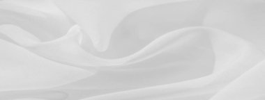 Bulanık beyaz kumaş yumuşak, akışkan kıvrımlı ve pürüzsüz bir dokuya sahiptir. Minimalist estetik ve ince ışık oyunu zarafet ve saflığı çağrıştırıyor, sakinleştirici ve huzurlu bir tasarım yaratıyor..