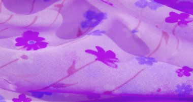 Yumuşak mor tonlarda bulanık kumaş ve küçük çiçek aksanları pürüzsüz ve ruhani bir örtü oluşturuyor. Narin çiçek desenleri akıcı şifon kumaşına romantik ve kadınsı bir dokunuş ekler..