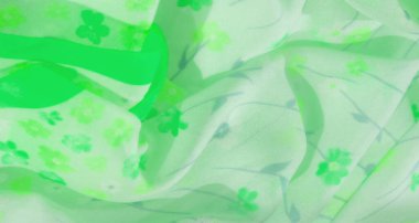 Açık yeşil çiçekli kumaş bulanıklığı küçük çiçekler ve akan mavi saplar sergiliyor. Canlı yeşil aksanlar ve yumuşak kıvrımlar herhangi bir tasarım projesi için canlı ve dingin bir doku oluşturur..