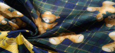 Yeşil ekose arka planda neşeli ayıcıklar ve çiçek motiflerinin yer aldığı canlı kumaş. Sarı aksanlar tüm canlılığı ve tuhaf tasarımı arttırır..