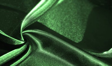 Karmaşık kıvrımları olan yeşil saten kumaş bulanıklığı ve lüks bir parıltı. İpeksi dokular düzgün bir akış yaratıyor, üst düzey tekstil görünümü gerektiren herhangi bir tasarım veya yaratıcı projeye zarafet ekliyor..