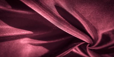 Zarif kıvrımlı bulanık kırmızı saten kumaş bir ışık ve gölge oyunu yaratarak lüks ve şehvetli bir dokuyla sonuçlanıyor. Arkaplan, tekstil veya moda tasarımları için mükemmel..