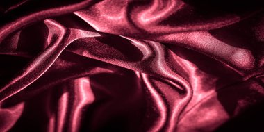 kıvrımlı ve buruşuk kırmızı satenler: Kırmızı satenin zengin, parlak dokusu ışığı zarif kıvrımlara ve ince kırışıklıklara yansıtır, göz alıcı, lüks bir hisle soyut bir tasarım yaratır.