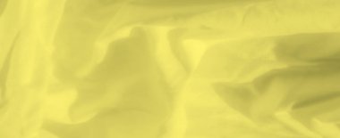 Yumuşak ve sıvı kıvrımlı açık sarı kumaş bulanıklığı, doğal ışıkla vurgulanmış. Pürüzsüz doku ve akışkan desenler, minimalist tasarım için mükemmel, sakin ve zarif bir zemin oluşturur..