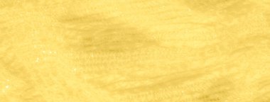 Detaylı dantel desenli parlak sarı bir kumaşın bulanık görüntüsü. Kumaşın parıltısı ve ince dokusu göz kamaştırıcı bir görsel efekt yaratır..