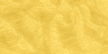 Işıldayan ipliklerle yıkanmış sarı dantel kumaş ve yumuşak ve parlak bir görüntü oluşturan karmaşık desenler. Doku zengin ve lüks, moda için mükemmel.