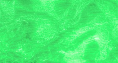 Parlak dantel desenli yumuşak yeşil kumaş bulanıklığı. Karmaşık detaylarını ortaya çıkarmak için ışığı yakalıyor. Malzeme zarifçe akıyor, büyüleyici bir görsel izlenim yaratıyor..