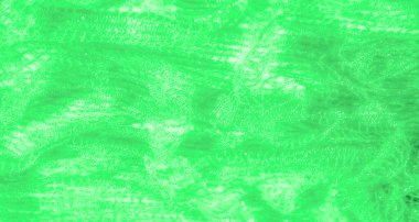 Işıldayan bir dokusu olan yeşil dantel kumaş bulanıklığı. Karmaşık örülmüş desen yumuşak kıvrımlarla akar, ışığı ruhani ve dekoratif bir şekilde yansıtır..