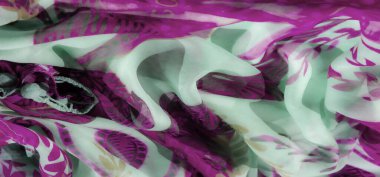 Pembe bir bulanıklık ve zarif girdap şekilleriyle süslenmiş nane yeşili kumaş. Hafif, havadar malzeme, modern, şık ve zarif bir estetik sunarak hareket ve dokuyu yakalar..