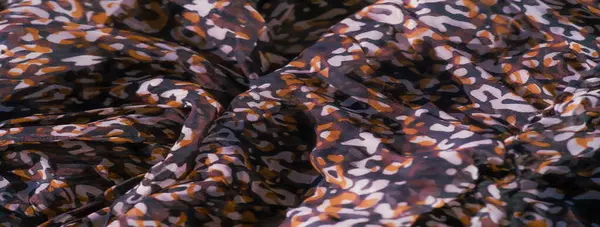 Karmaşık kırmızı, siyah ve beyaz motifler pürüzsüz, katıksız bir kumaş üzerinde. Katmanlı tasarım, karmaşık bir renk ve doku karışımı oluşturan dönen desenleri vurgular..