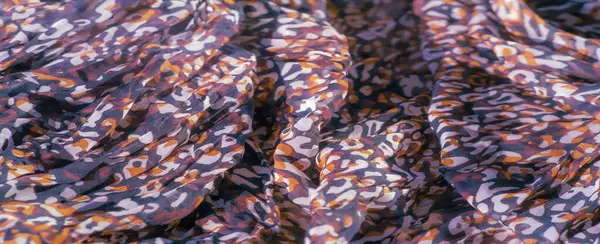 Siyah, kırmızı ve beyaz soyut motifler akan kumaş boyunca karışıyor. Yumuşak, katıksız malzeme bir zarafet ve hareket katmanı ekler, karmaşık detaylarla görsel akışı arttırır..