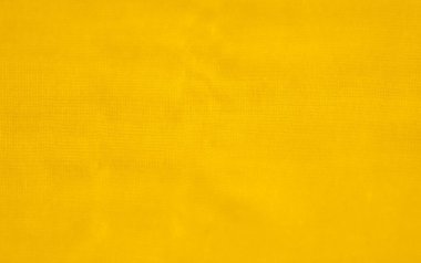 Görüntü. Yumuşak gölgeler derinlik ve hareket oluşturan yumuşak kıvrımlı sarı kumaşlardan oluşan bir yakın çekim. Malzemenin şeffaflığı ışığın filtrelemesini ve resme boyut eklemesini sağlar..
