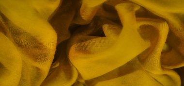 Sarı kumaşın bulanık görüntüsü ince dokusunu ve şeffaflığını sergiliyor. Katların soyut deseni sarı tonlarda dinamik ve canlı bir bileşim yaratır.