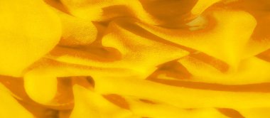 Akan, soyut bir tasarımı olan parlak sarı bir kumaşın bulanıklığı. Yumuşak kıvrımlar gölgeler ve röflelerin uyumlu bir karışımını oluşturarak hareketin önemini vurgulayan dinamik bir görsel deneyim sunuyor.