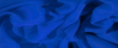 Mavi kumaş bulanıklığı akıcı ve doğal bir ritimle karmaşık kıvrımlar oluşturuyor. Işık yumuşakça kumaşın yüzeyiyle etkileşime girer ve soyut tasarımın ince detaylarını ortaya çıkarır..
