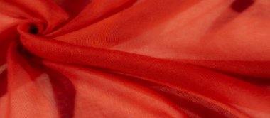 Yumuşak kıvrımlı ve hassas dokularda bulanık kumaş. Görüntü, kumaşın şeffaf ve canlı rengini yakalar. Zarif girdaplarla sarmalanır ve gölgeler oluşturur.