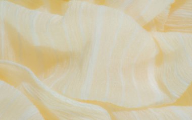 Açık sarı kumaştan bulanık, ince bir dokusu ve nazik dalgaları var. Kumaşlar yumuşak katlar ve parlak yüzey iç tasarım veya moda projeleri için ideal bir element haline getiriyor..
