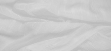 Yumuşak, beyaz kumaştan ince kıvrımlı ve ince bir dokusu var. Nazik dalgalanmalar soyut bir şablon oluşturur. Bu da onu arka plan ya da görsel öğeler için mükemmel kılar..