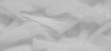 Yumuşak dalgalı ve dokulu beyaz kumaş bulanıklığı. Dalgalanan kıvrımlar, tasarım ve tekstil projelerinde asgari ve soyut kompozisyonlar için mükemmel bir sakinlik ve zarafet hissi yaratıyor.