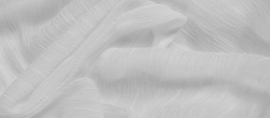 Bulanık Çıtır, yumuşak kıvrımlı ve yumuşak kıvrımlı beyaz dokuların detaylı bir görüntüsü. Kumaş, yumuşak yüzeyini ve ince dokularını vurgulayan hassas ışık ve gölge desenleri yaratıyor.