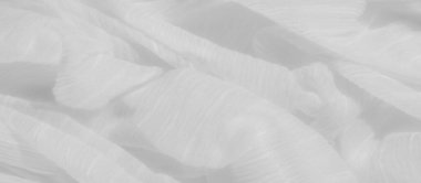 Yumuşak beyaz kumaş kıvrımlarından oluşan bulanıklık dingin ve narin bir doku yaratır. Hafif maddeler ince çizgiler ve karmaşık desenler sergiliyor, minimalist bir tarzda, saflık ve sakinlik hissi uyandırıyor..
