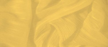 Dalgalanan kıvrımları olan parlak sarı bir kumaş ve ışığı zarif bir şekilde yakalayıp hareket hissi veren pürüzsüz, narin bir doku..