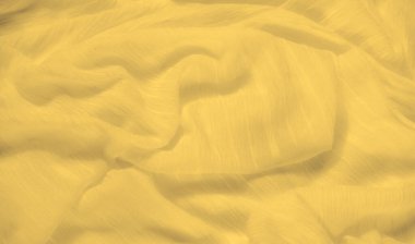 Bulanık sarı kumaş, yüzeyinde hafif dalgalanmalar olan dalga benzeri bir hareket yaratıyor. Yumuşak, güneşli doku ışığı yakalar, kumaşın pürüzsüz ve zarif akışını güçlendirir..