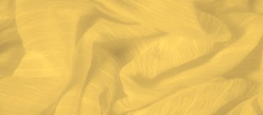 Sarı bir kumaşın bulanıklığı, yumuşakça buruşmuş çizgiler dinamik gölgeler yaratıyor. Doğal kıvrımlar ve gölgeler, kumaşın pürüzsüz, parlak yüzeyine derinlik ve boyut ekler..