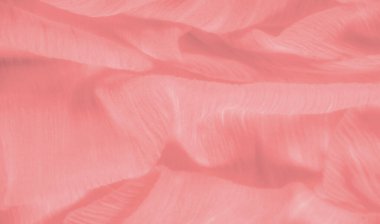 Yumuşak, süpürücü kıvrımlı, parlak lifli şeftali rengi bulanık kumaş. Materyaller yumuşak doku ve pastel şeftali rengi zarafet ve incelik yayar..