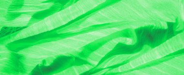 Dinamik kıvrımları ve iplik detayları olan parlak yeşil kumaş desenli, soyut bir kompozisyon sunuyor. Yumuşak parıltı bu eko-esinlenilmiş tekstil tasarımına derinlik katıyor..