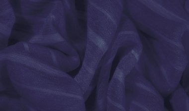 Dalgalı, yumuşak kıvrımlı, parlak bir yüzeyi olan zengin mavi kumaş bulanıklığı. Koyu mavi renk derinlik ve zarafet ekler, görsel olarak soyut bir doku yaratır.