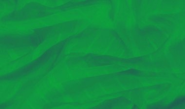 Yumuşak dokuları ve ince kıvrımlarıyla akan yeşil kumaş bulanıklığı pürüzsüz ve rahatlatıcı bir estetik oluşturuyor. Işık ve gölgeler, rahatlatıcı bir etki yaratmak için yüzeyde yavaşça dans eder..