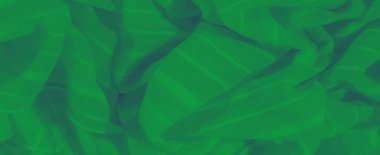 Hassas yeşil kumaştan bulanık, yumuşak gölgeli ve pürüzsüz çizgilerle örtülü. Kumaşın nazik kıvrımı rahatlatıcı ve doğal bir soyut etki yaratır..